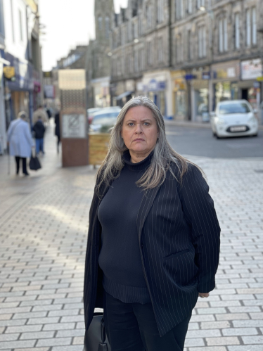 Roz McCall MSP on a high street in Fife at the camera